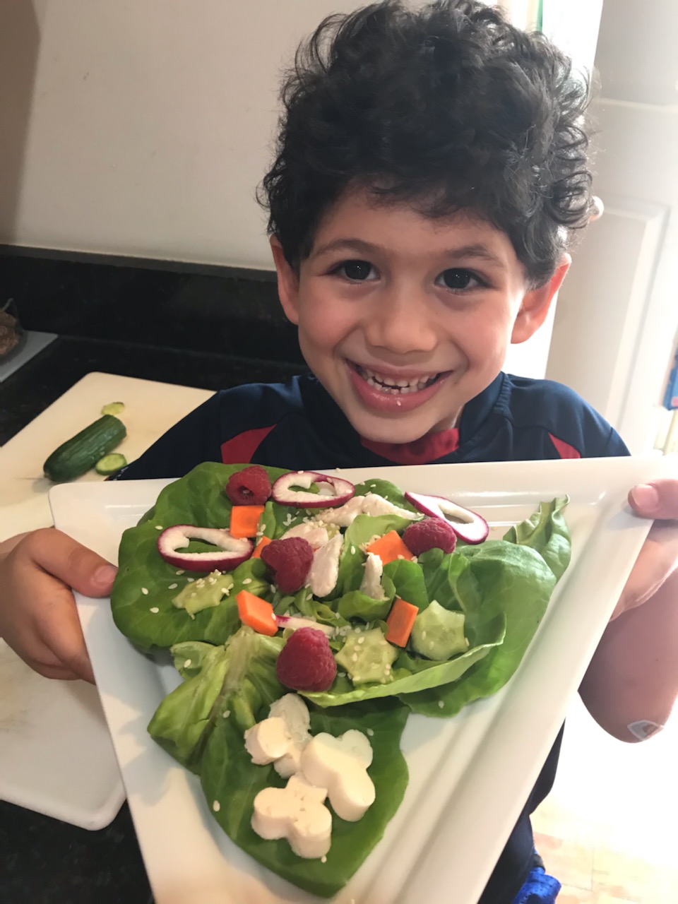 Kid with a salad full of shapes