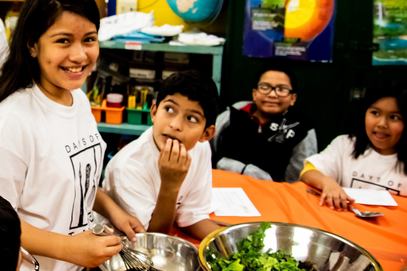 Days of Taste participants mix salad ingredients