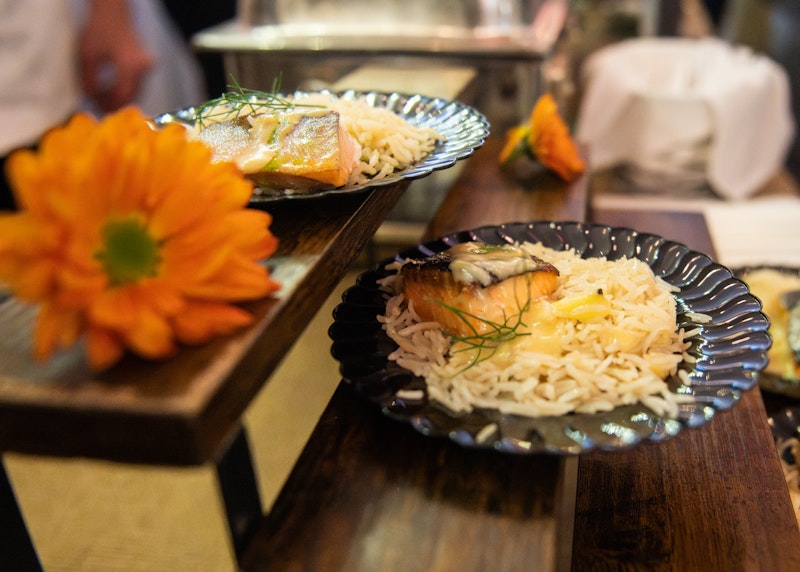 two plates of food with orange flower