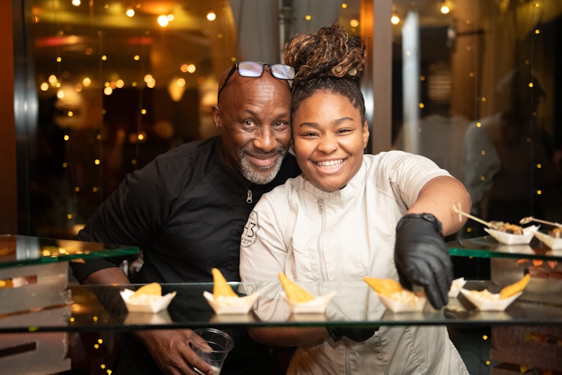 chefs smiling while serving food