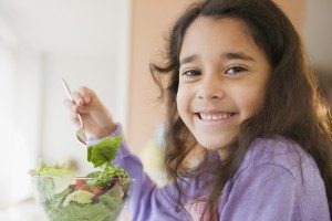 little girl eating salad